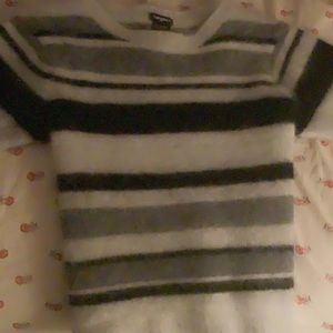 it’s a fuzzy shirt and could be a crop top if ur tall it’s striped (black,grey)!
